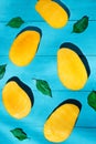 Exotic mango tropical fruit cutted on blue background Royalty Free Stock Photo
