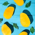 Exotic mango tropical fruit cutted on blue background Royalty Free Stock Photo