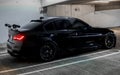 Exotic metallic black BMW M3 CS m power sports rear car with bright cherry red lights