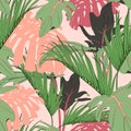 Exotic orange monstera and green tropical palm leaves, light peach background.