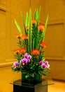 Exotic protea and pink orchids in glass vase