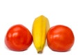 Exotic red and delicious tomatoes and banana with white background Royalty Free Stock Photo