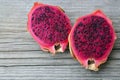 Exotic ripe pink Pitaya or Dragon fruit. Red Pitahaya tropical fruit cut in half on old wooden table.