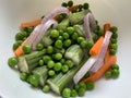 Exotic salad with drumsticks green peas carrots and onion rings Royalty Free Stock Photo