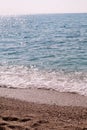 Exotic sandy beach, tropical blue mediterranean sea with waves and sea foam. Beautiful natural environment, panorama, landscape. Royalty Free Stock Photo