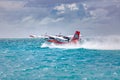 Exotic scene with seaplane on Maldives sea landing. Vacation or holiday in Maldives concept background