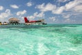 Exotic scene with seaplane on Maldives sea landing. Vacation or holiday in Maldives concept