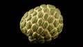 Exotic sugar apple fruit showcasing a distinctive honeycomb pattern on black backdrop Royalty Free Stock Photo