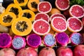 Exotic summer fruits laid out in shopping mall or market. Dragon fruit, pineapple, persimmon, mango, annona cherimola Royalty Free Stock Photo