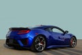 Exotic super sports car prototype on cement with a plain light blue sky background