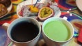 Exotic tea and fruits on colored table