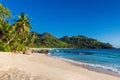 Exotic Tropical beach at sunset and coconut palms on Seychelles. Royalty Free Stock Photo