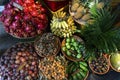 Exotic and tropical fruits on the market of Asia, Thailand, Vietnam. Mini bananas, longan, pitaya, papaya Royalty Free Stock Photo