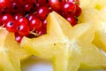 Exotic tropical star fruit and red currant berry
