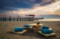 Exotic twilight dining seat on the beach. Royalty Free Stock Photo