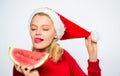 Exotic winter holiday. Celebrate new year summer. Girl wear santa hat eat slice watermelon white background. Summer Royalty Free Stock Photo