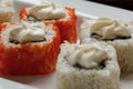 Exotically japanese seafood, roll are lying on a white plate. Close up.