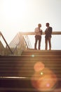 Expand your business by linking up with other businessmen. Low angle shot of two businessmen using a cellphone on top of Royalty Free Stock Photo