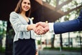 Expand your contacts by meeting new businesspeople. a beautiful young businesswoman shaking hands with an unrecognizable Royalty Free Stock Photo