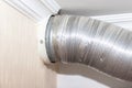 Expandable metallic aluminium corrugated air-conditioning ventilation pipe in kitchen connecting a cooker hood and a ventilation