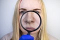 Expanded pores, black spots, acne, rosacea close-up on the nose. A woman is being examined by a doctor. Dermatologist examines the