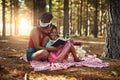 Expanding their mind and imagination. a mother and her little daughter reading a book together in the woods. Royalty Free Stock Photo