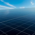 Expansive array of solar panels under a clear blue sky. The panels are arranged