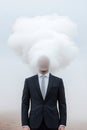 In an expansive, empty landscape, a well-dressed man stands with a smooth, featureless face. Soft mist swirls around him