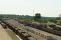 Expansive freight station under daylight with numerous wagons and equipment Royalty Free Stock Photo