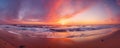 expansive panoramic view of a colorful sunset over a serene coastal beach, with soft golden sand, gentle waves panorama