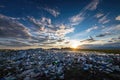 Vast Landfill of Plastic Waste Under a Dramatic Sunset Sky Royalty Free Stock Photo