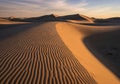 Expansive sand dunes with rippled patterns, stretching towards Royalty Free Stock Photo