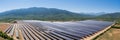 Expansive solar panels harnessing green energy on a radiant summer day at a sustainable solar farm