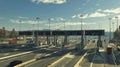 Expansive toll road interchange with numerous lanes and pay stations for background wallpaper Royalty Free Stock Photo
