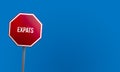 expats - red sign with blue sky Royalty Free Stock Photo