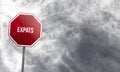 Expats - red sign with clouds in background Royalty Free Stock Photo