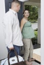 Expectant Couple Exiting Home