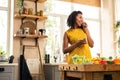 Expectant mother eating raisins and cooking dinner. Royalty Free Stock Photo