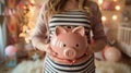 Expectant Mother Holding Piggy Bank for Future Baby Savings. Royalty Free Stock Photo