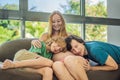 Expectant parents, mom, dad, and their eldest son share a heartwarming moment on the sofa, discussing the exciting Royalty Free Stock Photo