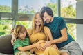 Expectant parents, mom, dad, and their eldest son share a heartwarming moment on the sofa, discussing the exciting Royalty Free Stock Photo