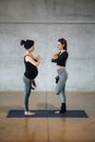 Expectant woman working out at studio with her personal trainer Royalty Free Stock Photo