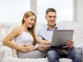 Expecting family with laptop computer Royalty Free Stock Photo