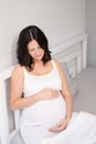 expecting mother with huge tummy. sweet pregnancy time. happy woman with pregnant belly in light bedroom. home cozy