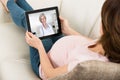 Expecting Woman Videoconferencing With Doctor