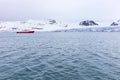 Expedition boat in front of a massive glacier Royalty Free Stock Photo