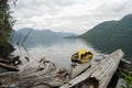 An expedition canoe sits at the shore of a calm Great Central Lake, Vancouver Island, BC, Canada Royalty Free Stock Photo