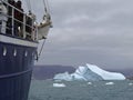 Expedition ship in front of an iceberg