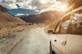 Expedition vehicle with baggage on it roof on the mountain road