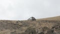 Expeditionary off-road vehicles slowly rides on the mountain rocky road.